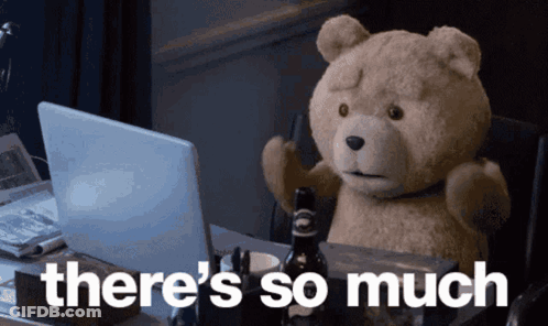 A Teddy Bear Sitting In Front Of A Laptop With The Words " There 'S So Much " Above It GIF