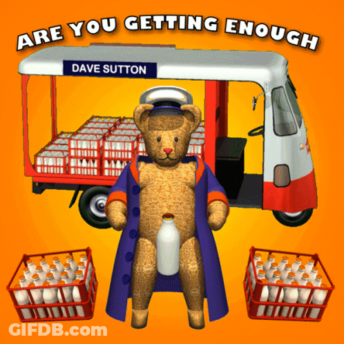 A Teddy Bear Standing In Front Of A Milk Truck That Says Dave Sutton GIF
