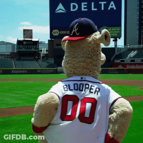 A Teddy Bear Wearing A Jersey That Says Booper 00 Stands On A Baseball Field GIF