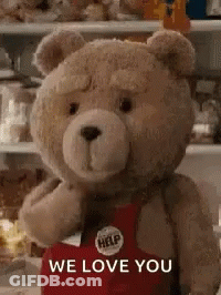 A Teddy Bear Wearing A Red Apron Is Standing In Front Of A Refrigerator . GIF
