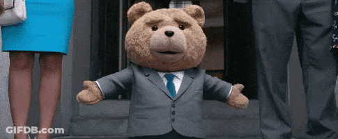 A Teddy Bear Wearing A Suit And Tie Is Standing In Front Of A Woman In A Blue Skirt GIF