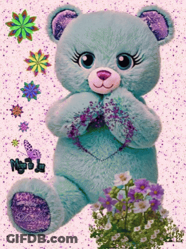 A Teddy Bear With A Heart On Its Chest Is Surrounded By Flowers GIF