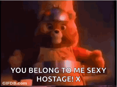 A Teddy Bear With A Helmet On Says `` You Belong To Me Sexy Hostage ! X '' GIF