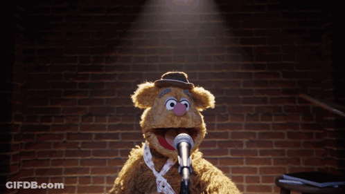Teddy Bear With Hula Hoop Standing In Front Of Microphone GIF