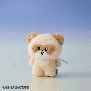 A Teddy Bear With A Pink Flower On Its Head Is Holding A Violin GIF