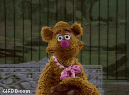 A Teddy Bear With A Pink Nose And Tie GIF