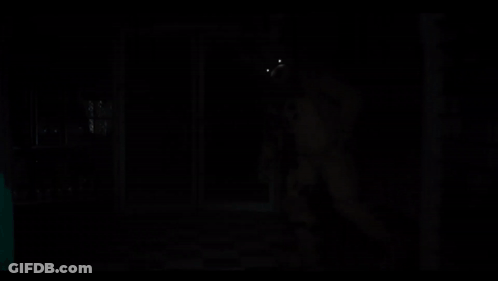 A Teddy Bear With Glowing Eyes Is In The Dark GIF