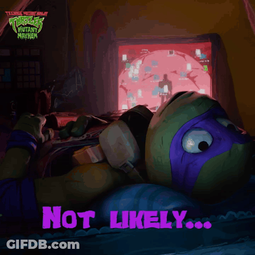 A Teenage Mutant Ninja Turtle Laying In Front Of A Computer Screen GIF