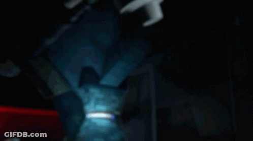 A Teenage Mutant Ninja Turtle With A Blue Headband Is Laying Down GIF