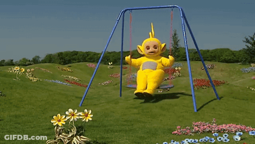 A Teletubbies Character Is Sitting On A Swing In The Grass GIF