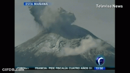 A Television Screen Shows A Volcano Erupting And Says Televisa News At The Top GIF