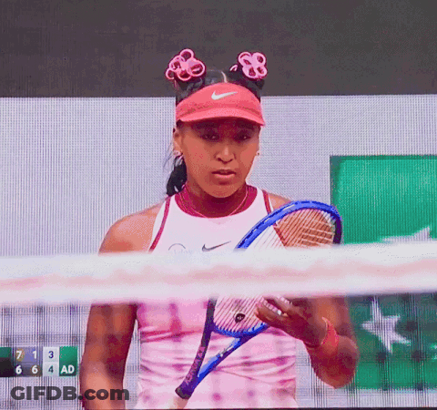 A Tennis Player Holds A Tennis Racquet In Front Of A Scoreboard With The Number 7 On It GIF