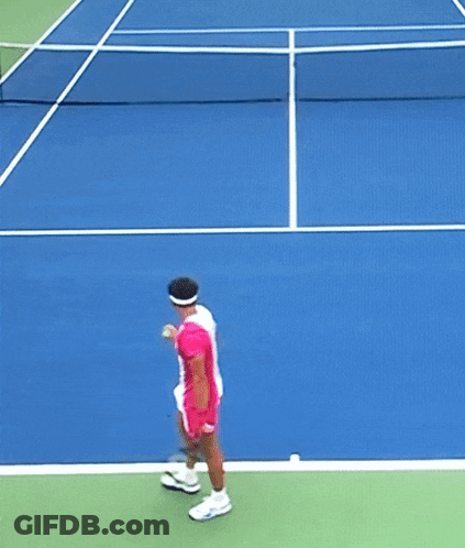 A Tennis Player In A Pink And White Outfit Is Swinging A Racket GIF
