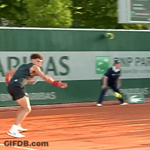 A Tennis Player Is About To Serve The Ball In Front Of A Bnp Paribas Advertisement GIF