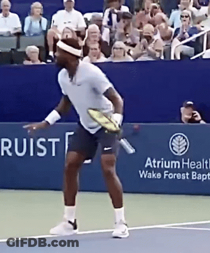 A Tennis Player Is Holding A Tennis Racquet On A Court Sponsored By Atrium Health Wake Forest Baptist Church GIF