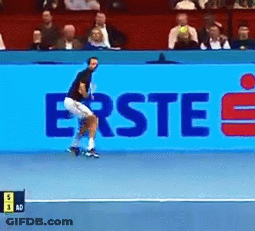 A Tennis Player Is Jumping In Front Of A Large Blue Sign That Says Erste GIF