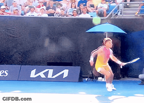 A Tennis Player Is Jumping In The Air In Front Of A Kia Banner GIF