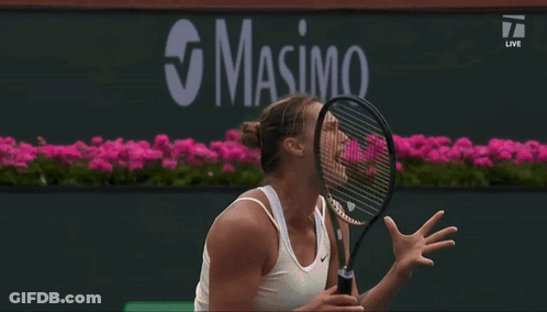 A Tennis Player Is Jumping In The Air While Holding A Racquet In Front Of A Bnp Paribas Banner GIF