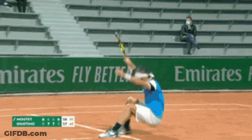A Tennis Player Is Kneeling Down On The Court In Front Of An Emirates Advertisement GIF