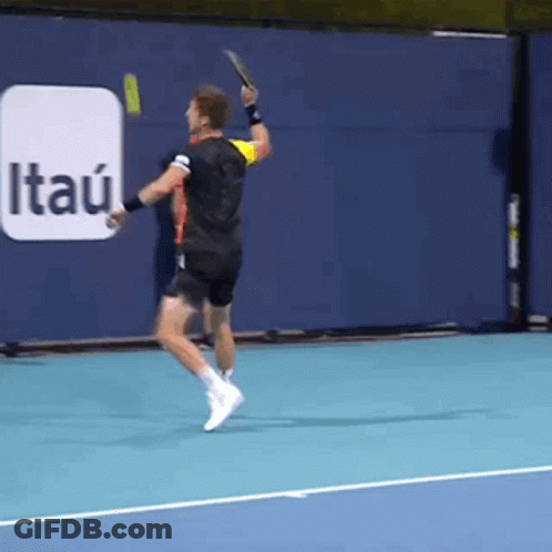 A Tennis Player Is Swinging A Racket On A Court With An Itau Ad In The Background GIF