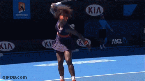 A Tennis Player Is Swinging A Racquet On A Blue Court With Kia Advertisements In The Background GIF