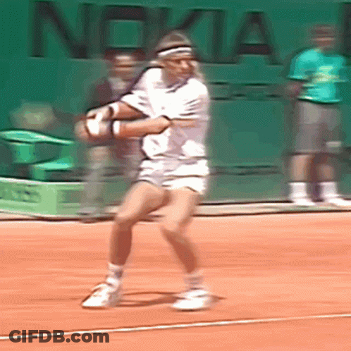 A Tennis Player Is Swinging A Tennis Racket On A Court With Nokia Written On The Wall Behind Him GIF