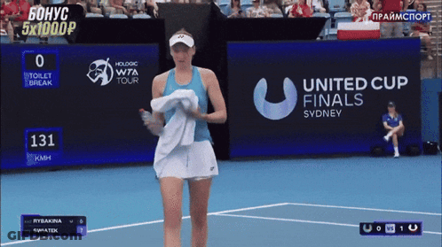 A Tennis Player Is Walking On A Court In Front Of A United Cup Finals Sign GIF