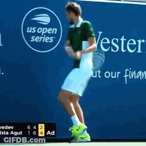 A Tennis Player Jumps In Front Of A Us Open Series Sign GIF