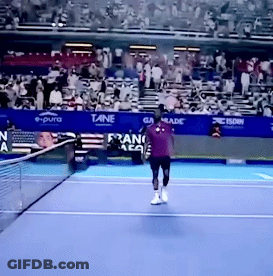 A Tennis Player On A Court With A Banner That Says E Pura GIF