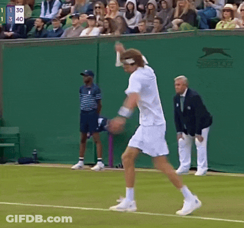 A Tennis Player On A Court With A Slazenger Logo On The Wall Behind Him GIF
