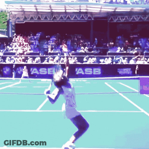 A Tennis Player Serves The Ball In Front Of A Banner That Says Asb On It GIF