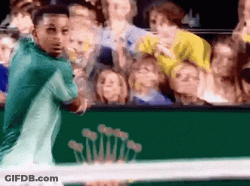 A Tennis Player Stands In Front Of A Green Rolex Sign GIF