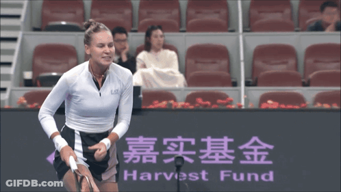 A Tennis Player Stands In Front Of A Harvest Fund Sign GIF