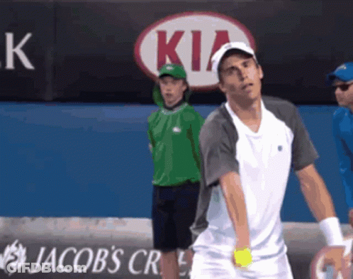 A Tennis Player Stands In Front Of A Kia Ad GIF