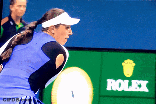 A Tennis Player Stands In Front Of A Rolex Advertisement GIF