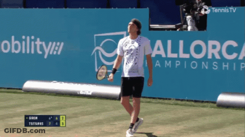 A Tennis Player Stands In Front Of A Sign That Says Mobility GIF