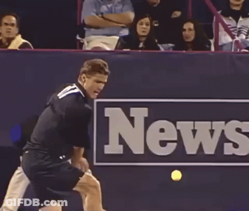 A Tennis Player Swings A Racket In Front Of A News Sign GIF