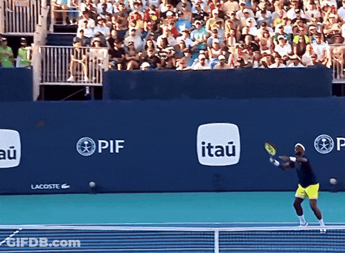 A Tennis Player Swings A Racquet In Front Of A Wall That Has Itau Written On It GIF