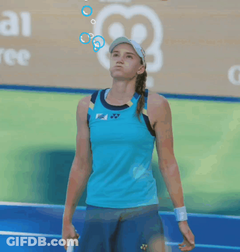 A Tennis Player Wearing A Blue Tank Top And Blue Shorts GIF