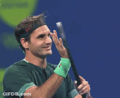 A Tennis Player Wearing A Headband Holds A Tennis Racquet GIF