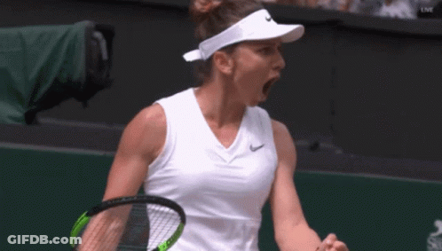 A Tennis Player Wearing A Nike Visor Is Holding A Tennis Racquet GIF