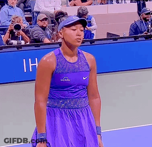 A Tennis Player Wearing A Purple Workday Top GIF