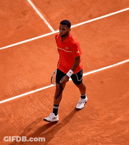 A Tennis Player Wearing A Red Shirt That Says Lacoste On It GIF
