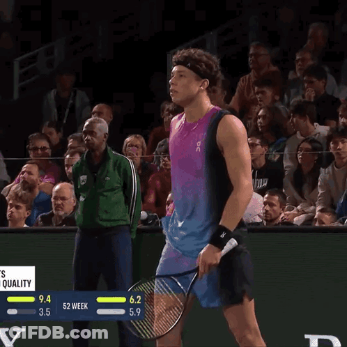 A Tennis Player Wipes His Nose With A Towel While Holding A Racquet GIF