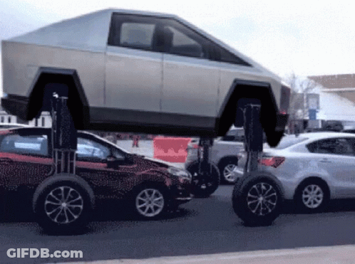 A Tesla Car Is Sitting On Top Of A Red Car GIF