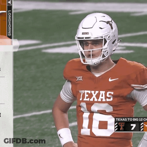 A Texas Football Player Wearing A White Helmet Stands On The Field GIF