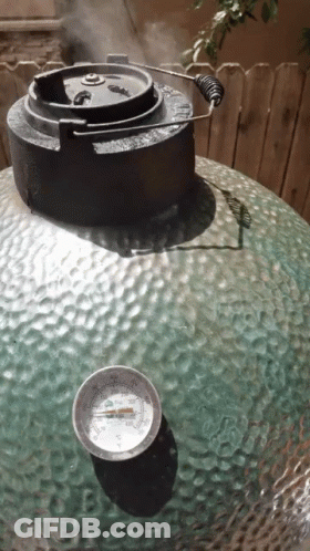 A Thermometer Sits On A Table Next To A Large Green Object GIF