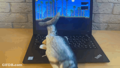 A Thinkpad Laptop With A Fish Toy On It GIF