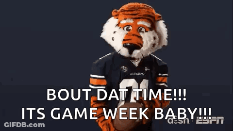 A Tiger Mascot Is Holding A Football And Says Bout Dat Time Its Game Week Baby ! GIF