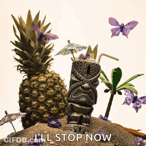 A Tiki Statue Sits On A Sandy Beach Next To A Pineapple And Palm Trees GIF